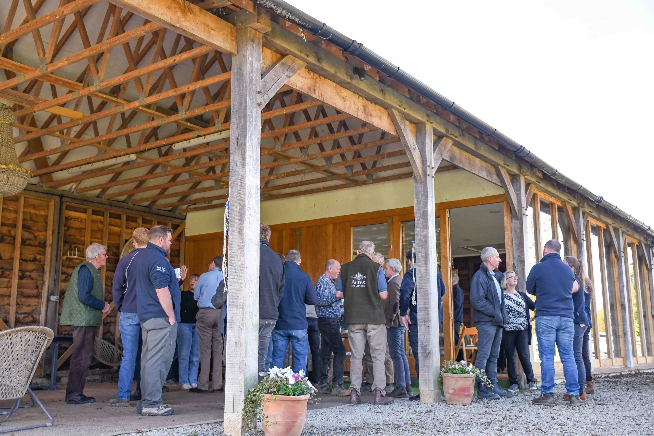 People standing in the Green Farm barn for lunch during the Upper Beult Cluster Meeting.